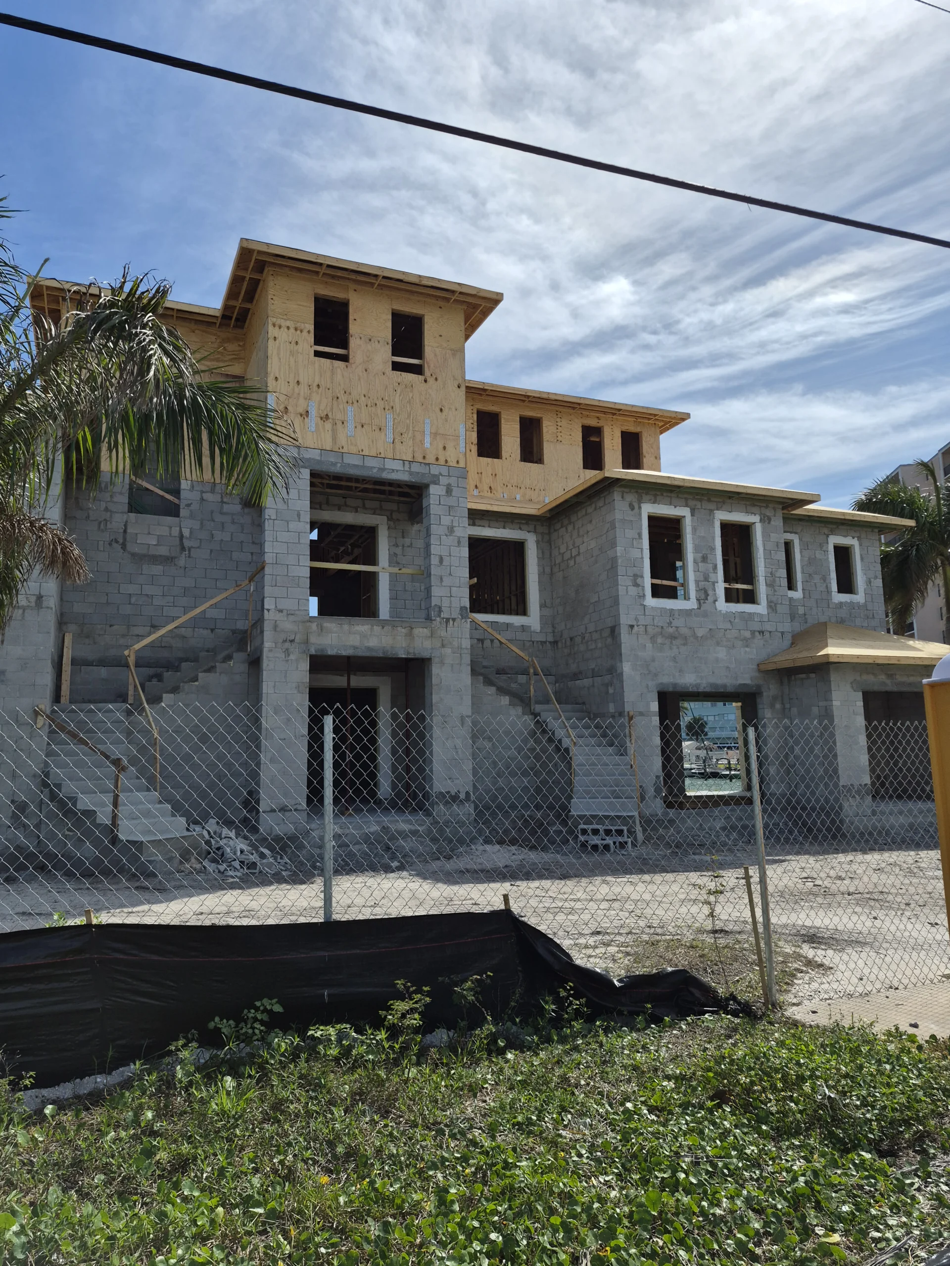 Custom home shell construction with slab, block, framing, and trusses